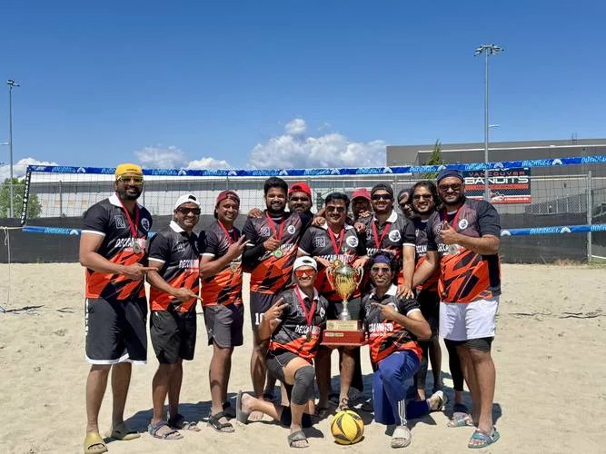 Deccan United players on the sand court holding the BC Super Kings trophy